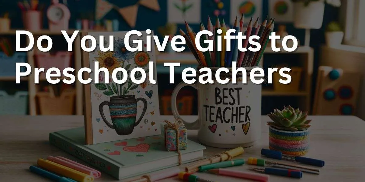 The image shows a collection of gifts for preschool teachers arranged on a classroom table. It includes a custom mug inscribed with 'Best Teacher' and filled with colorful pens and pencils, a small potted succulent, a handcrafted thank you card with bright designs, and a book on creative teaching methods. The setting reflects a cheerful, educational preschool atmosphere