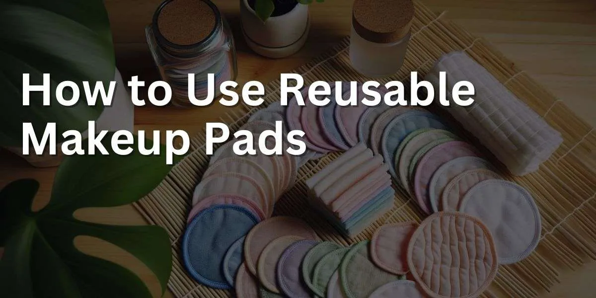 Wide-angle photograph of reusable makeup pads arranged artistically on a bamboo mat. The pads are of various pastel shades, indicating different textures for different skin types. Alongside the pads, there's a glass jar for storage, a small laundry bag for washing the pads, and a leafy plant in the background for a natural, eco-friendly atmosphere.
