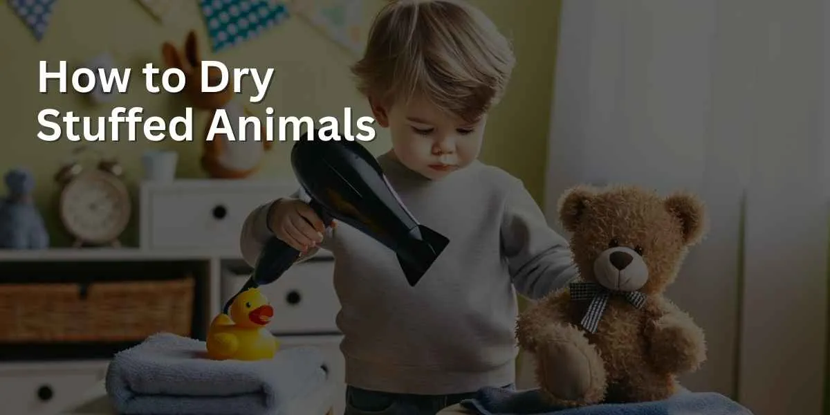 A child, concentrated and careful, is using a hair dryer to blow dry a damp teddy bear and a duck, placed on a towel on a table. The child is standing on a small stool in a bright, cheerful room with playful decorations.