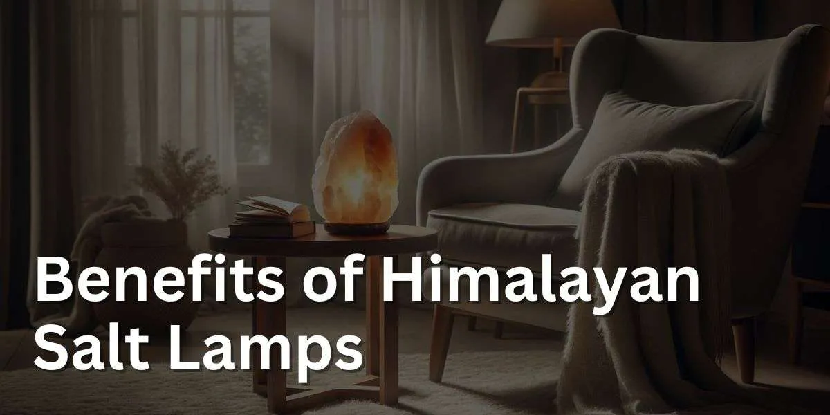 image of a Himalayan salt lamp glowing with a warm light, placed on a wooden side table. The room is designed for relaxation, with a muted color scheme of soft greys and creams. There is a plush armchair with a throw blanket draped over one arm next to the table.