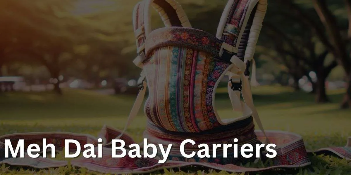 A Meh Dai baby carrier with colorful patterns and straps, set in a sunny park with trees and grass in the background.